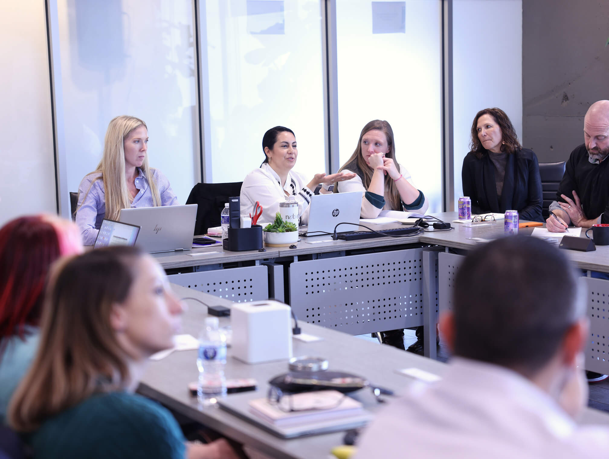 people at meeting with hp laptop