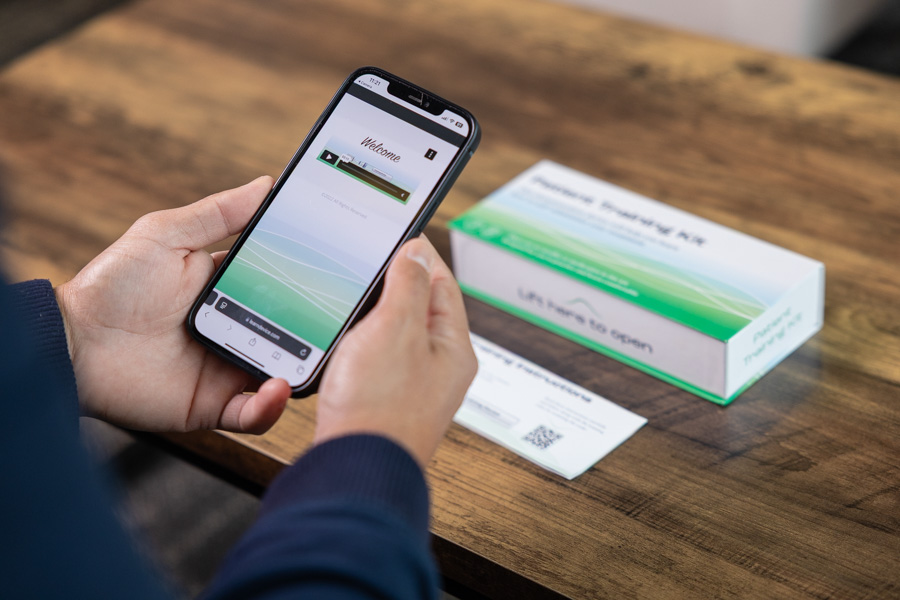 Patient using phone app to engage with therapy support.