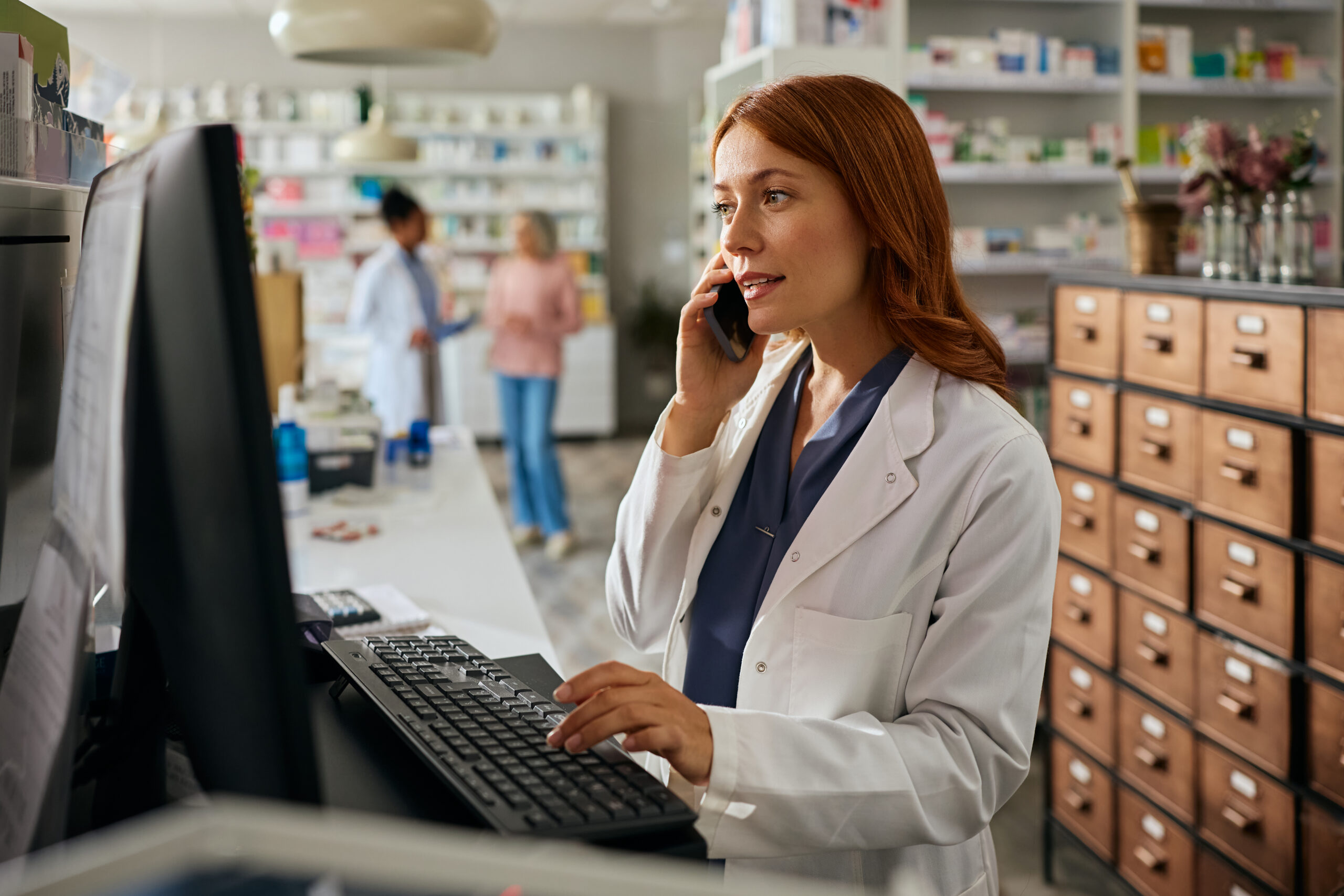 Female Pharmacist talking with patient on the phone