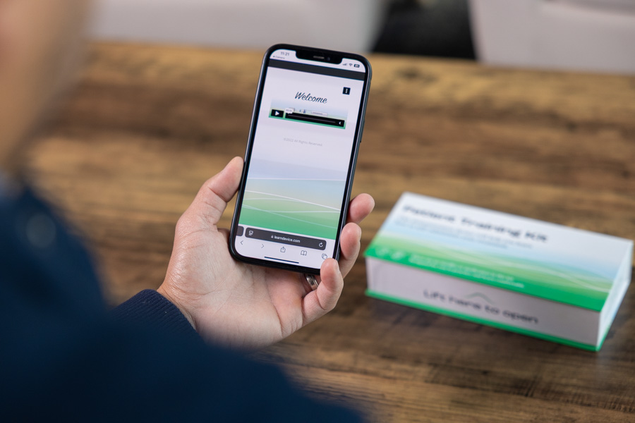 woman with phone with training instructions for training device