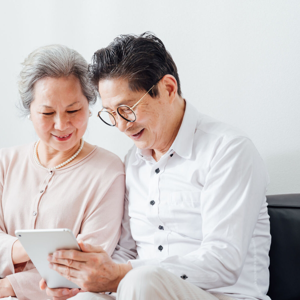 Senior Couple using tablet at home